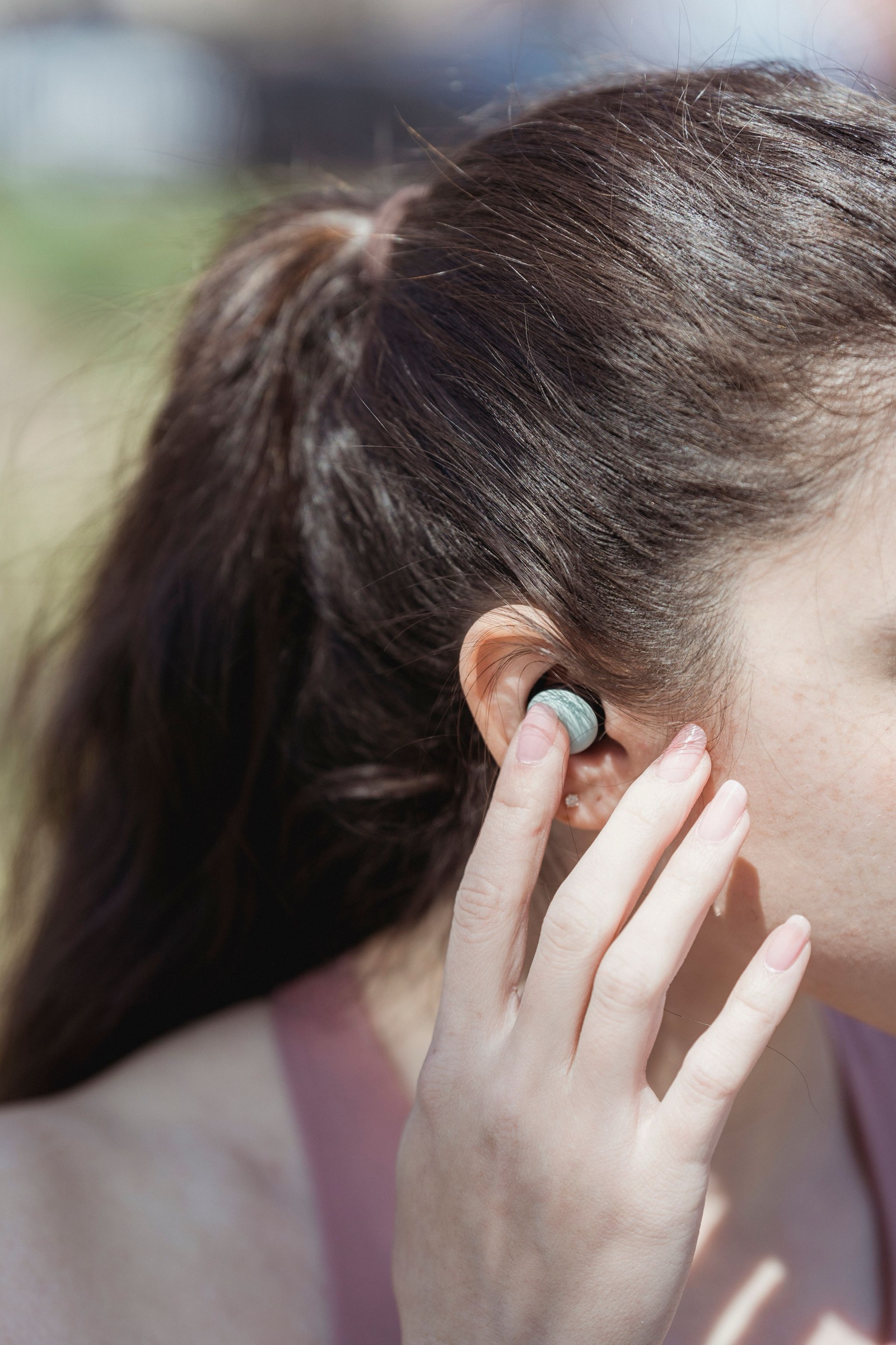 Someone putting in an earbud