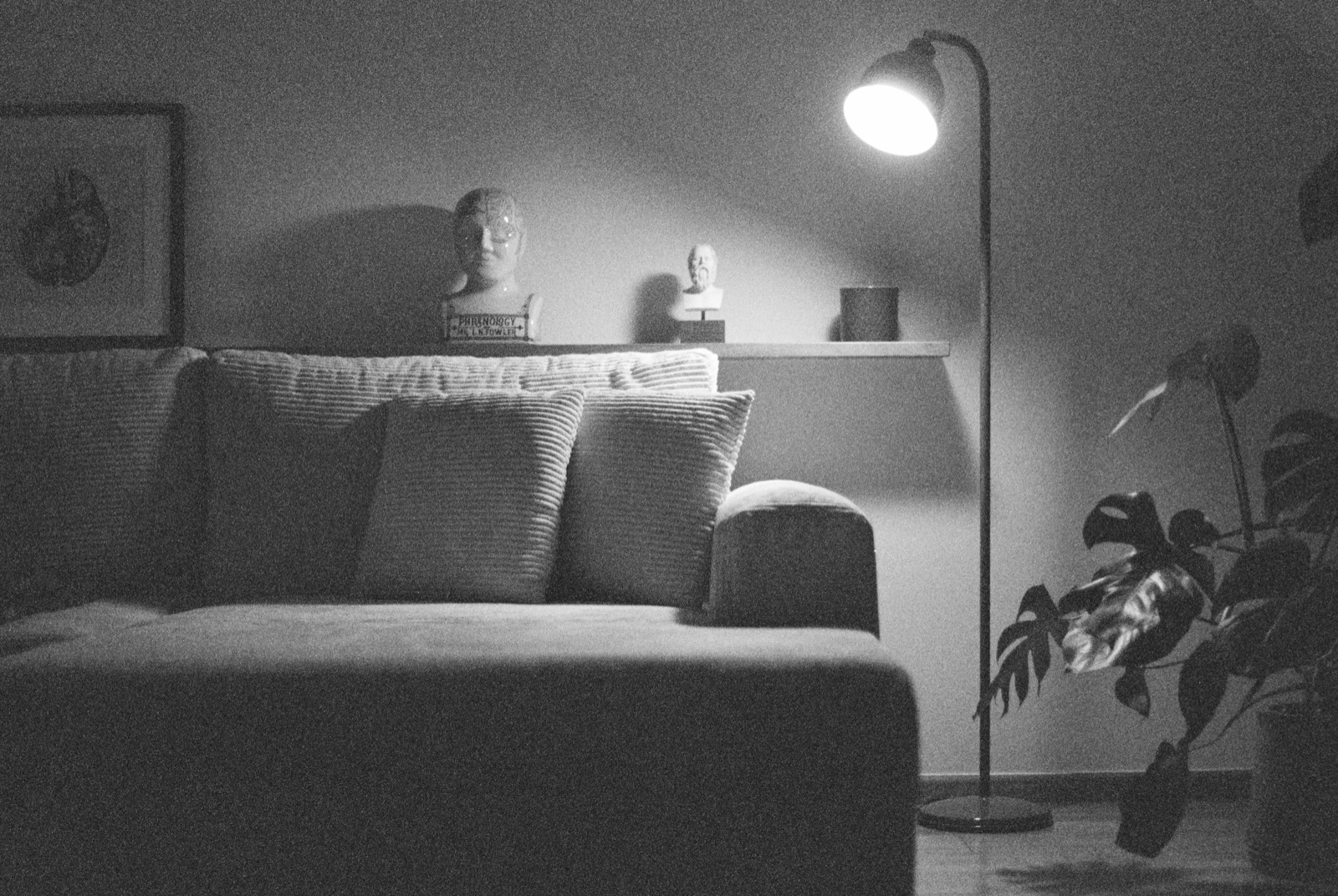 A calm living room at night, lit by a single lamp